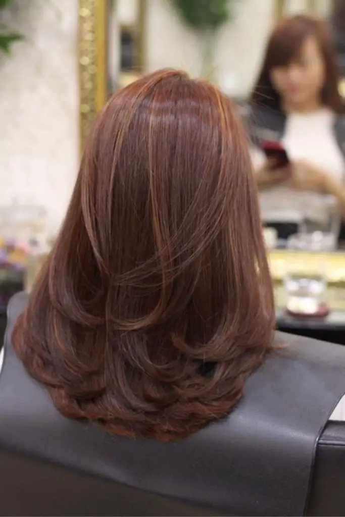 Tóc phái nữ layer dài uốn nắn đuôi tóc